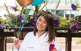 A Woman is seen holding balloons and a drink celebrating her birthday Elmwood Spa