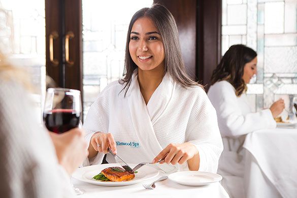 Woman enjoying a meal in her spa robe at Terrace Restaurant