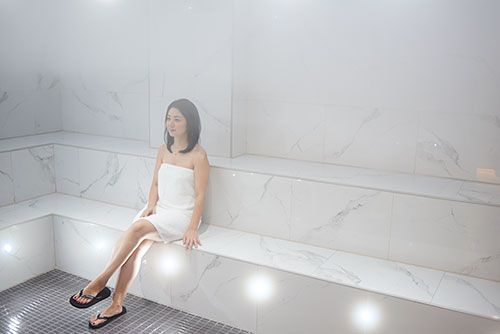 A woman relaxes in the steam room, one of the many water spa perks at Elmwood Spa