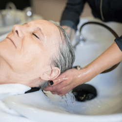 Close up of a woman receiving a scalp treatment